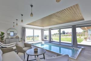 a living room with a large swimming pool at Relax V Kraji in Žernov