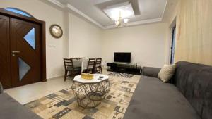 a living room with a couch and a table at Amzing two bedrooms in the middle of amman in Amman