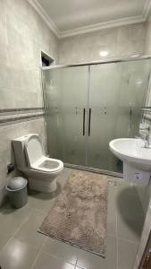 a bathroom with a toilet and a sink at Amzing two bedrooms in the middle of amman in Amman