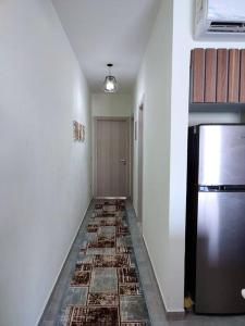 a hallway with a refrigerator and a tile floor at The Groove Ain Sokhna in Ain Sokhna