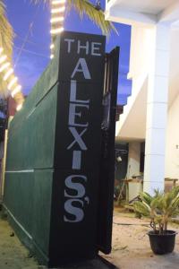 a black and white sign on the side of a building at The Alexis's Guest House in Negombo