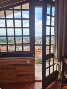 a room with a large window with a view at Casa Na Montanha Da Neve in Seia