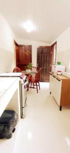 a kitchen with a counter and a table with chairs at Recanto das Neves in Miguel Pereira +38 photos