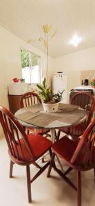 a dining room table and chairs with a potted plant on it at Recanto das Neves in Miguel Pereira