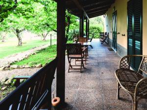 a porch with chairs and tables and a table and chairs at Don Federico Country Inn in Moscufo