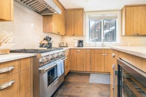 a kitchen with wooden cabinets and a stove top oven at 330 W Pacific B townhouse in Telluride