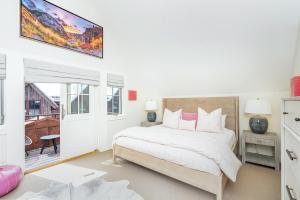 a bedroom with a bed and a tv on the wall at 330 W Pacific B townhouse in Telluride