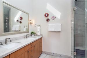 a bathroom with two sinks and a large mirror at 330 W Pacific B townhouse in Telluride +20 photos