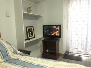 a bedroom with a bed and a television on a table at The Affectionate One in Louis Trichardt