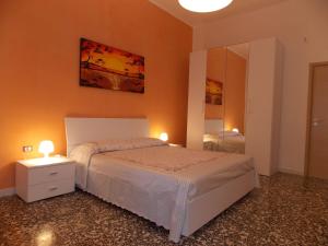 A bed or beds in a room at Appartamenti Blue House