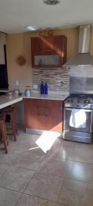 a kitchen with a stove and a counter top at MI CASA in El Calafate
