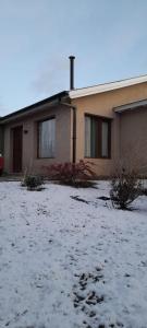 a house with snow on the ground in front of it at MI CASA in El Calafate