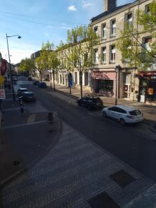 a city street with cars parked on the road at Moulins F3 hyper centre de Saint Dizier in Saint-Dizier