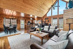 a living room with a couch and a table at Kate's Cabin - 3 min to Dollywood! Cabin with Hot tub, Game Room, and Resort Pool! in Sevierville