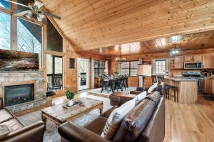 a living room with a couch and a fireplace at Kate's Cabin - 3 min to Dollywood! Cabin with Hot tub, Game Room, and Resort Pool! in Sevierville