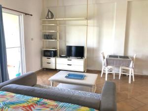 a living room with a couch and a table at El Dorado Condo 208A in Punta Cana