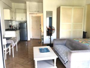 a living room with a couch and a table and a kitchen at El Dorado Condo 208A in Punta Cana