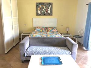 a living room with a couch and a bed at El Dorado Condo 208A in Punta Cana +6 photos