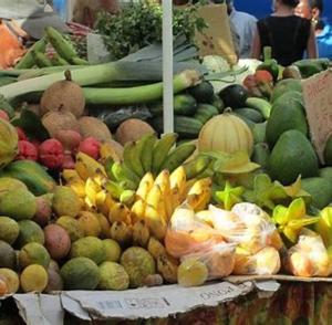 a display of fruits and vegetables in a market at COLOCATION CITE URBAINE in Pointe-à-Pitre