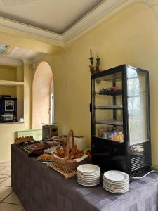 einen Tisch mit Teller mit Lebensmitteln in der Küche in der Unterkunft Hôtel Miramar in Vence
