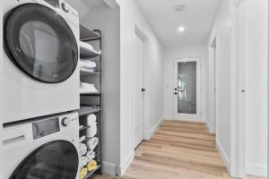 a laundry room with a washer and dryer at Mid-Century Modern Dream Retreat in West Kelowna