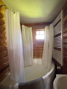 a bathroom with a toilet and a tub with a window at Eifel-Lounge BLOCKHAUS mit Kamin Garten Balkon nahe Köln Therme Brühl Phantasialand in Weilerswist +52 photos