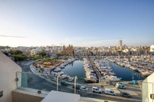 a marina with a bunch of boats in the water at Seafront Apartment-Hosted by Sweetstay in Tal-Pietà