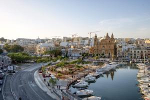 a view of a city with boats in a harbor at Seafront Apartment-Hosted by Sweetstay in Tal-Pietà