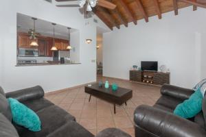 a living room with two couches and a coffee table at Pineapple Villa 142 condo in Roatán