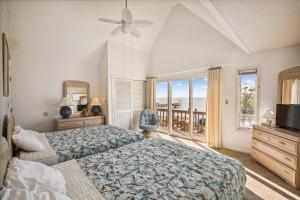 a bedroom with a bed and a view of the ocean at 2816 - Tranquil Sound by Resort Realty in Duck