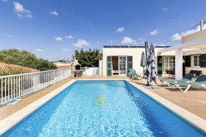 a swimming pool in the backyard of a house at Villa Jordi - Cala en Porter in Cala en Porter