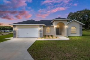a house with a garage in a yard at Villa Ilse: New Stylish Home With Private Pool in Inverness
