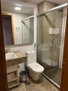 a bathroom with a toilet and a shower and a sink at CULLINAN DELUXE in Brasília