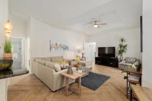 a living room with a couch and a tv at Villa Ilse: New Stylish Home With Private Pool in Inverness