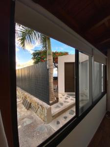 a view from a window of a house with a palm tree at CASITA LAS VISTAS in Frontera