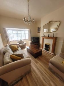 a living room with a couch and a fireplace at Polly's Place - A lovely 3 bed first floor flat, near to beach with free parking in Clacton-on-Sea