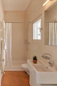 a bathroom with a sink and a toilet and a window at Casa Navegna in Minusio