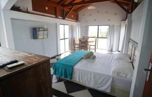 パリョサにあるVilla Do Marのテーブル付きの部屋にベッド付きのベッドルームがあります。
