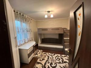 a small room with a bunk bed and a bathroom at Halal Apartment in Osh