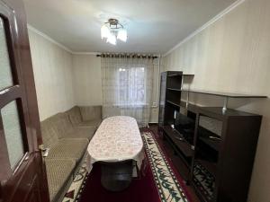 a small living room with a couch and a table at Halal Apartment in Osh