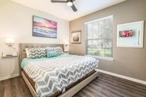 a bedroom with a bed and a window at The Happy Place! - Upgraded Fun Windsor Home in Kissimmee
