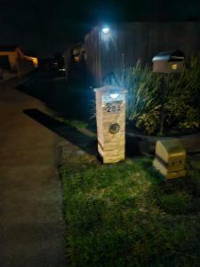 a parking meter on the side of a street at night at Di's B&B in Matamata