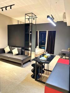 a living room with a couch and a table at Axon Residence By Perkasa Suites in Kuala Lumpur