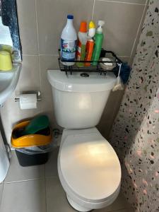 a bathroom with a toilet with a shelf on the top at 1BR Townhouse + Netflix in Marilao