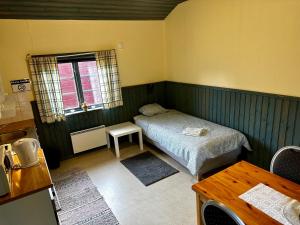 Habitación pequeña con cama y ventana en Ramsjö Camping Stuga, en Ramsjö