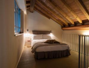 a bedroom with a bed in a room with wooden ceilings at Locanda Cà dei Santi in Induno Olona