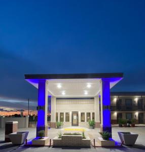 a large building with blue lights in front of it at Hotel 81 El Reno in El Reno