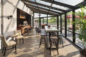 a patio with tables and chairs and windows at Delta Hotels by Marriott Minneapolis Northeast in Minneapolis