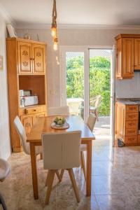 a kitchen with a table and chairs and a dining room at Can Content - Playa de Muro in Muro