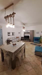 a dining room and living room with a table and chairs at Casa BiBa in Villasimius